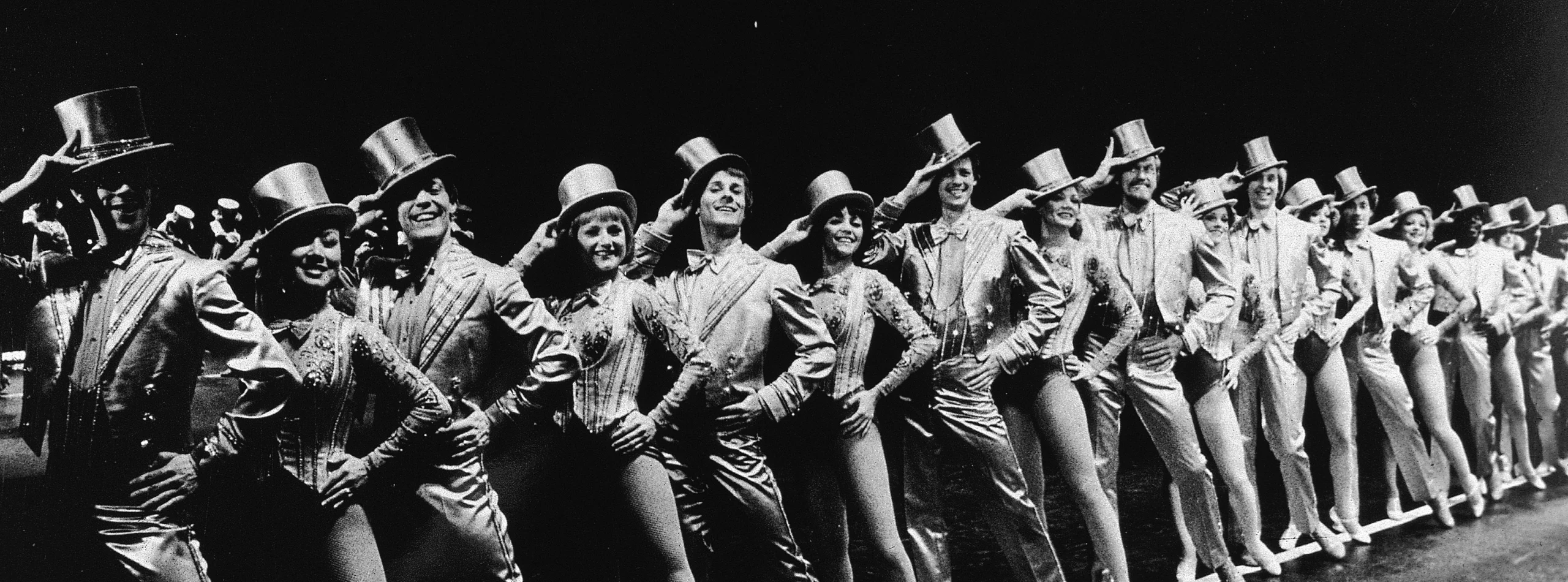 A Chorus Line kickline in gold top hats