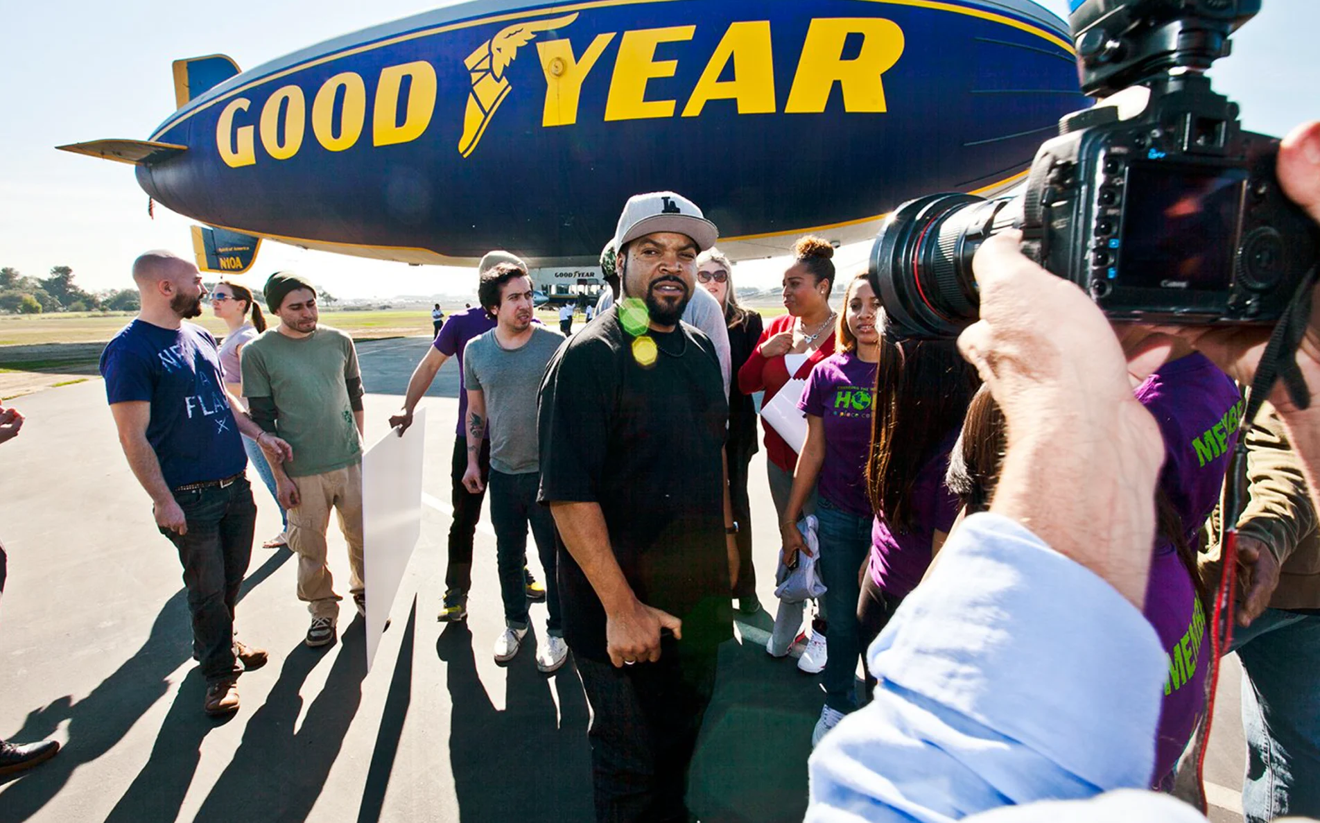 Ice Cube and crew in front of the Goodyear blimp