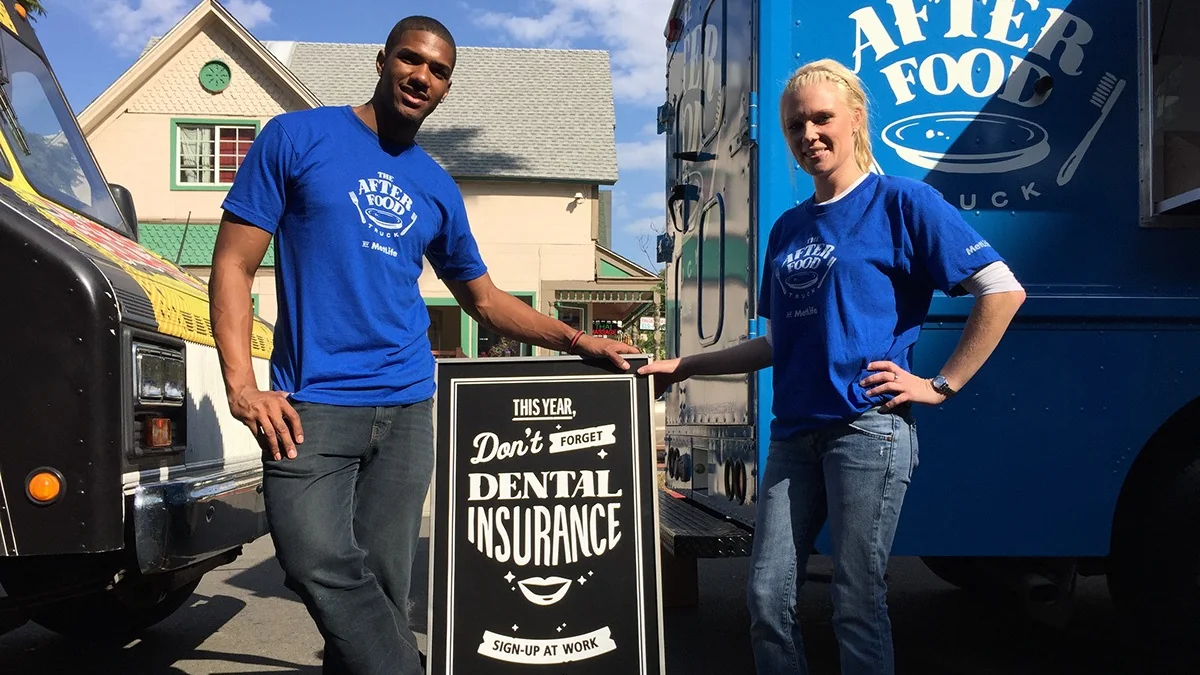 After Food Truck crew flanking the dental insurance sign-up board